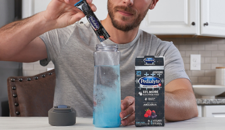 Man mixing Pedialyte in Water