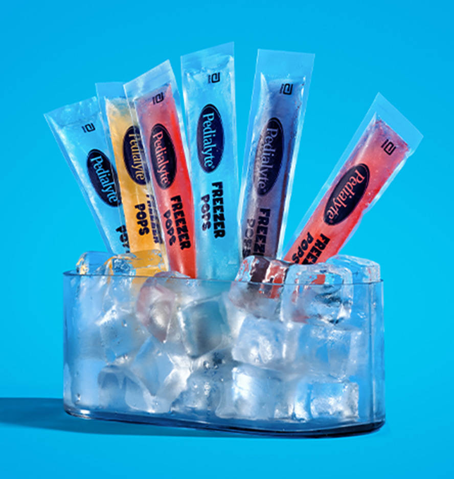 Pedialyte freezer pops including grape, blue raspberry, cherry, and orange flavors displayed in a container of ice, a cool way to stay hydrated.